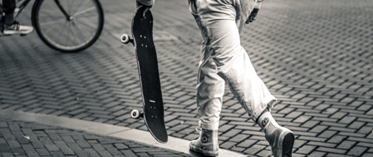 grayscale photography of man playing skateboard