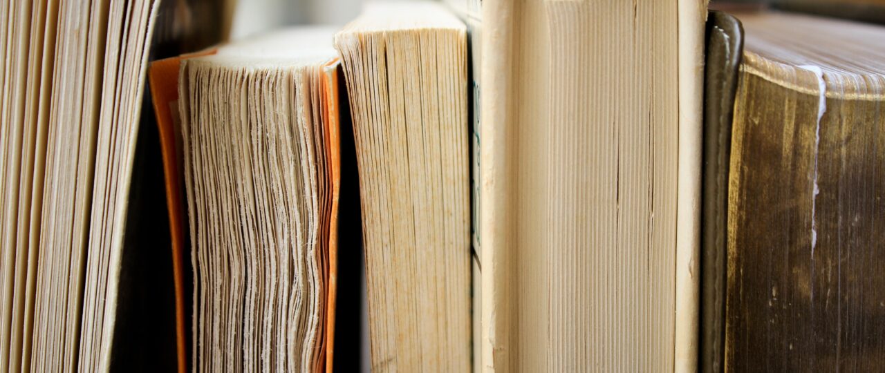 macro photo of five assorted books
