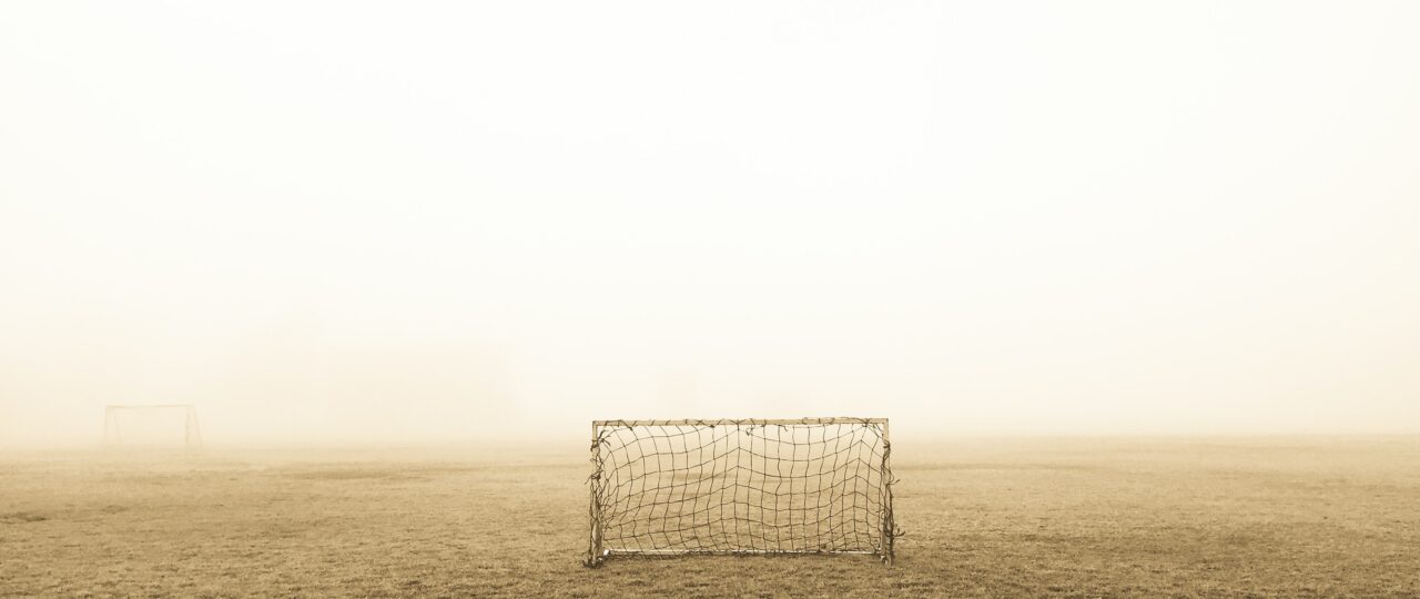 soccer goal on brown field